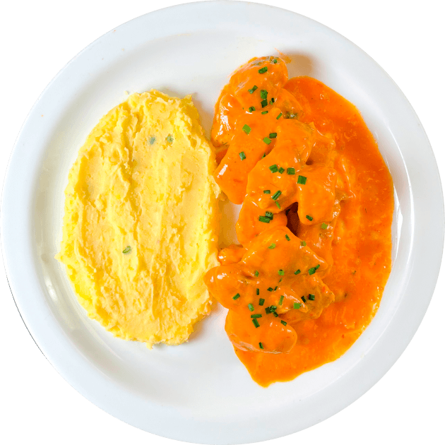Pollo en salsa de pimiento rostizado con puré de papa.