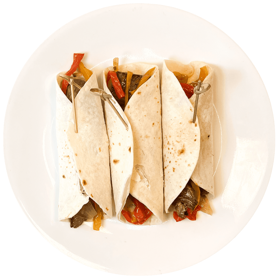 Fajitas de lomo con tortillas de harina, guacamole, queso y ensalada.